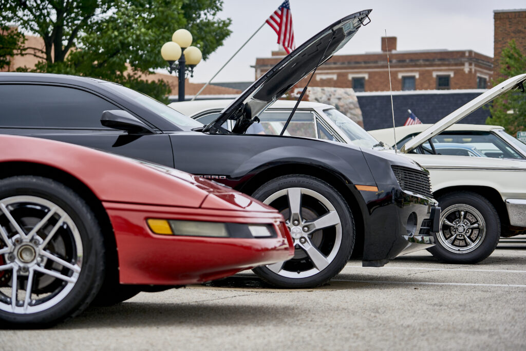 Cars with hoods up parked on street